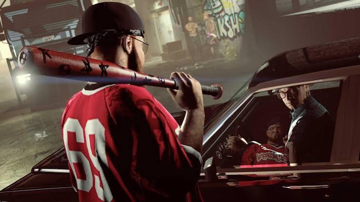 A gang member in a red jersey with a baseball bat on his shoulder, standing by a car